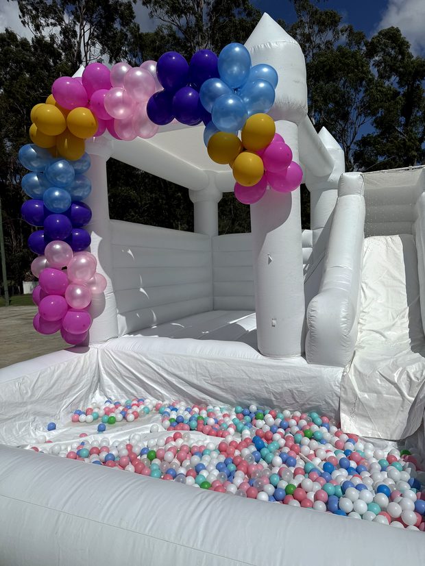 Balloon garland and backdrop styled beside the castle