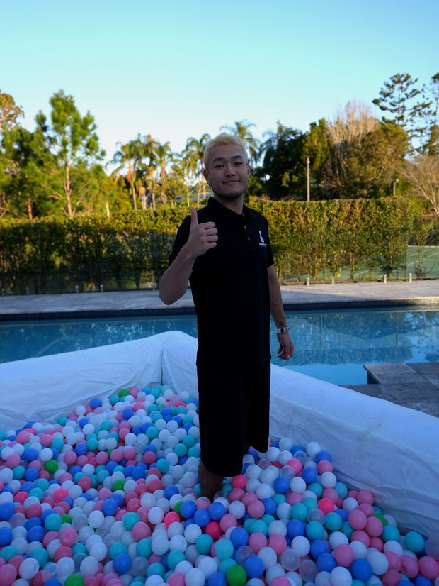 Ball pit filled with pastel balls beside the pool