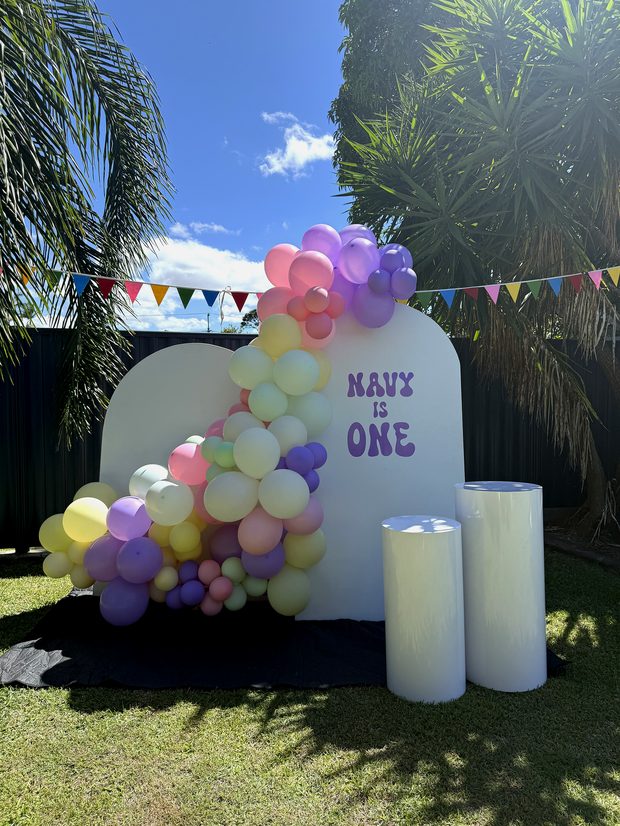 Styled backdrop corner with balloons and plinths
