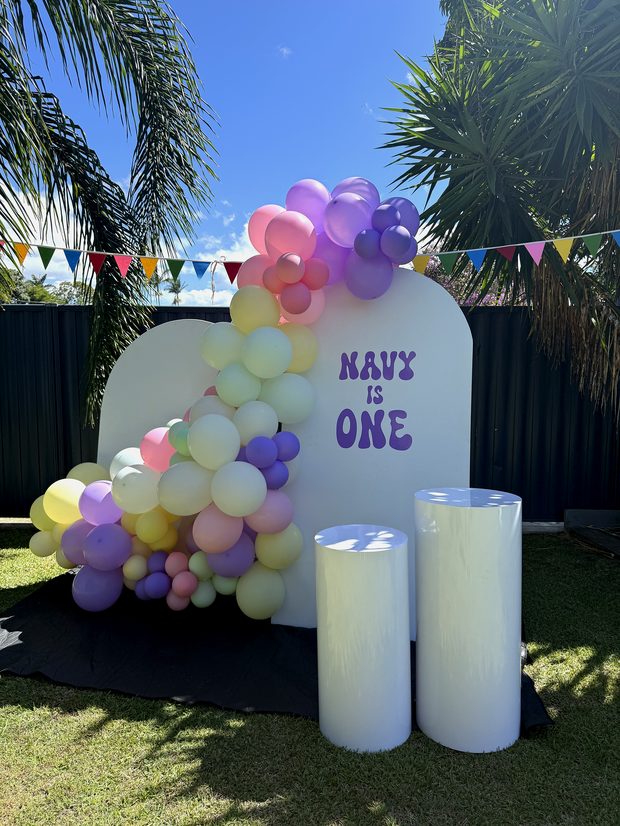 Balloon arch and plinths styled as a backdrop