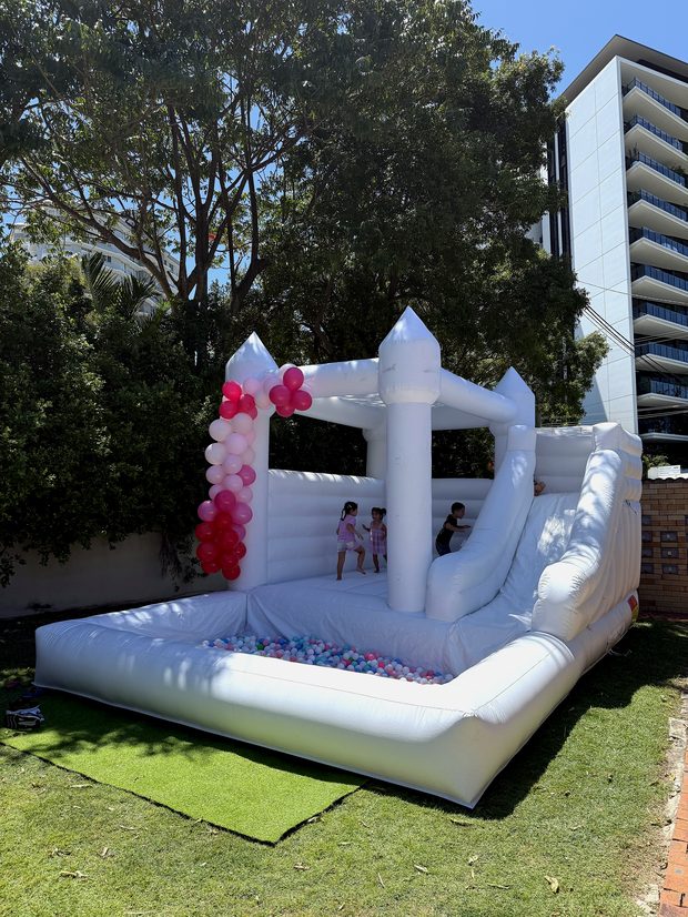 White castle with slide on a lawn