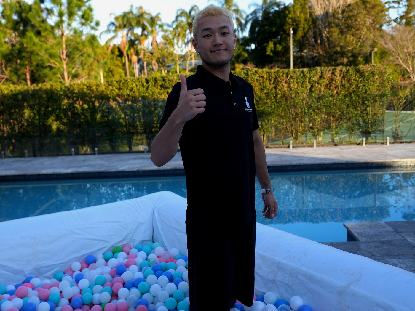 Ball pit filled with pastel balls beside a pool