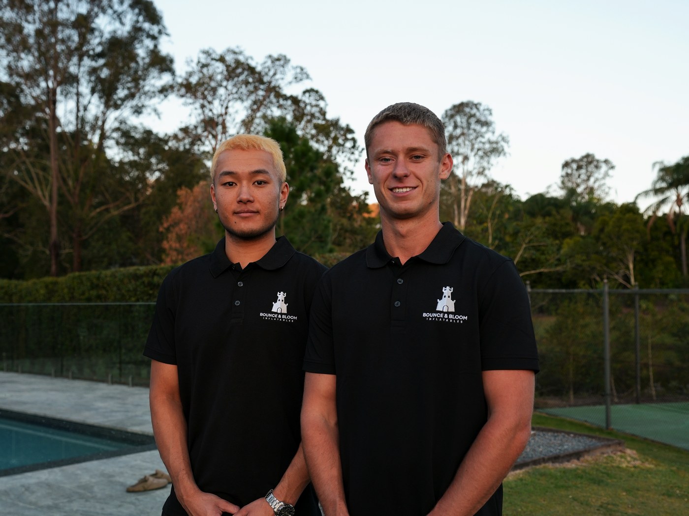 The two owners of Bounce and Bloom Inflatables in branded polos